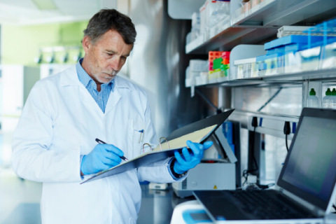 Technician documenting notes in a lab