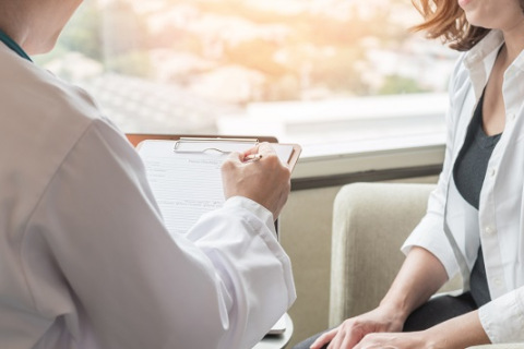 Woman talking to doctor